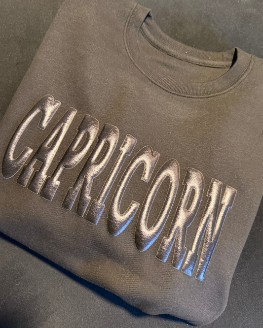 BLACK ON BLACK PUFF ZODIAC SWEATER